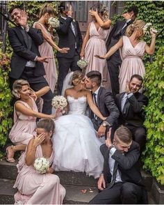 the bride and groom are surrounded by their wedding party