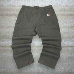 "Vintage Carhartt Carpenter Pants Dark Olive Green Canvas Baggy Fit Dungarees Work Wear Painters White Logo 90s Skate / Streetwear Great Condition: 7/10 (small marks, aka some character) Men's Size:  Waist: 38\" Length (inseam): 28\" Leg Opening: 9\" Thigh Opening: 13\" Front Rise: 13\"" Carhartt Carpenter Pants, Carhartt Carpenter, Skater Streetwear, 90s Skater, 90s Skate, Skate Streetwear, Vintage Carhartt, Carpenter Pants, Dark Olive Green