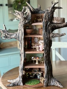 a wooden table topped with a tree house