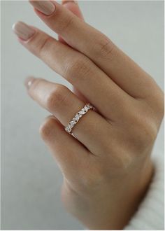 a woman's hand with a diamond ring on it