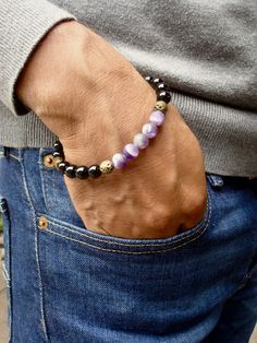 "Men's Spiritual Protection, Love, Clarity Bracelet in an artistic classy array of Semi Precious Matte Amethyst 8mm, Black Agate 8mm, Hematites rondelles in brass tone, two Brass Filigree beads 8mm and brass rondelles. A stunning colors' contrast with a classy style for the bohemian man. Very elegant bracelet fits a wrist of a standard size 7.5 inches or 19.05 cm to 8.5 inches or 21 cm since it has been beaded with high quality elastic cord. Let me know if I should adjust it to your size. Agates Black Amethyst 8mm Bead Bracelets, Black Amethyst Bracelets With 8mm Beads, Black Amethyst Bracelet With 8mm Beads, Black Amethyst Gemstone Bracelets, Black Amethyst Gemstone Bracelet, Onyx Bracelets With Natural Stones For Gift, Spiritual Onyx Bracelets As Gift, Onyx Bracelets With Natural Stones As Gifts, Spiritual Onyx Bracelets For Gift