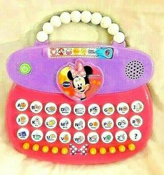 a pink and purple toy typewriter with mickey mouse on it