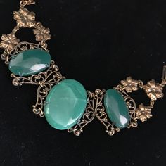 This bracelet was made by Sadie Green company in the seventies. Sadie Green would use antique and vintage components and marry them together to make great jewelry. They specialize in using green sea glass, these smooth pieces being a jade color.  Please note that the large 1.25 x .75 one in the middle has been cracked, but still intact. The price reflects this.  The glass cabs are set into antiqued brass filigree settings. The bracelet is all linked together and measures 7 inches fitting an average woman's wrist. The closure is a tongue in barrel style and still works well. The detail of the metal open work links are fantastic. It is a classic Belle Epoque design and weighty due to the glass components. This piece of jewelry is sent in a bubble pack envelope via US postal service, first cl Ornate Green Jewelry With Intricate Design, Antique Green Jewelry For Formal Occasions, Vintage Jade Jewelry For Jewelry Making, Adjustable Vintage Jade Bracelets, Green Metal Bracelets For Formal Occasions, Green Handmade Bracelets For Formal Events, Green Handmade Bracelets For Formal Occasions, Formal Green Metal Bracelets, Vintage Jade Bangle