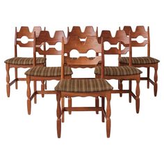 a set of six wooden chairs sitting next to each other