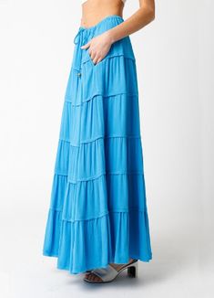 It's time to channel our in inner Donna Sheridan in the Milos Aqua Blue Tiered Maxi Skirt! Aqua blue woven fabric shapes this tiered maxi skirt with a beaded drawstring tie and a mid-rise fit. Style with kitten heels and crop top for a cute and easy outfit! DETAILS & FIT Relaxed Fit. 100% Rayon. Machine Wash Cold. Imported. Donna Sheridan, Easy Outfit, Word Bracelet, Tiered Maxi Skirt, Denim Accessories, Fit Style, Outfit Details, Simple Outfits, Aqua Blue