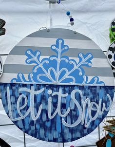 there is a sign that says let it snow on the side of a building in front of some shoes