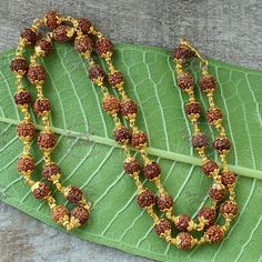 Embrace the divine with this beautifully handcrafted 5 Mukhi Rudraksha Mala featuring elegant copper capping. This sacred necklace is perfect for spiritual seekers, yogis, and meditators ️. The 5 mukhi Rudraksha is known for promoting inner peace, clarity, and overall well-being 🌿, making it an essential tool for daily meditation and mindfulness practices 🕉️. The intricate copper capping not only enhances durability but also adds a stunning aesthetic appeal to this mala, perfect for both spiritual use and as a meaningful fashion accessory ✨. Whether you're wearing it for prayer, meditation, or to complement your style, this mala aligns your energy with peace and balance 🙏. Key features: - 5 Mukhi Rudraksha beads 8MM for spiritual protection and harmony 🌸 - Handcrafted with durable copp Rudraksha Necklace, 5 Mukhi Rudraksha, Tibetan Mala, Stunning Aesthetic, Mindfulness Practices, Buddhist Mala, Rudraksha Mala, Rudraksha Beads, Yoga Mala