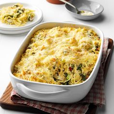 a casserole dish with broccoli and cheese in it on a table