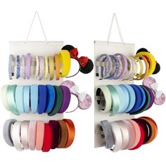 several different colored ribbons are hanging on the wall and in front of an assortment of headbands