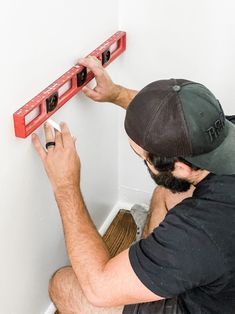 a man is working on an electrical outlet