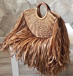 ✨Prepare to elevate your summer style with our handcrafted MACRAME BAG with FRINGE. This macrame luxury bag is not just a piece of accessory, but a statement of elegance and sophistication. It's perfect for those who love to stand out from the crowd while maintaining a sense of timeless fashion. *Bag details: Height with handles - 28cm/11" Width - 35cm/14" Depth - 5cm/2" Length of fringe - 20cm/8" 🌾Handmade Macrame Bag - Each of our boho bags is carefully hand-knitted, showcasing the skill and Luxury Bohemian Beach Bag For Everyday Use, Luxury Bohemian Rectangular Beach Bag, Luxury Modern Shoulder Bag For Beach, Luxury Braided Handles Beach Shoulder Bag, Luxury Fringe Bags For Beach, Luxury Fringe Straw Bag For The Beach, Luxury Fringe Straw Bag For Beach, Luxury Fringe Bags For The Beach, Luxury Summer Bags With Fringe