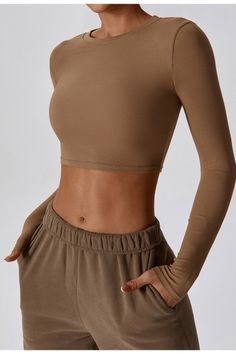 The Thalia Ribbed Round Neck Long Sleeve Active Top features a flattering, body-hugging fit that accentuates your curves while offering maximum support. The crop top length is perfect for showing off your toned midriff and pairs perfectly with high-waisted leggings or shorts. Fabric & fit: 78% Nylon 22% Elastane Model is wearing size Small. Body Hugging Tops, Active Top, Swimwear Sale, High Waisted Leggings, Mocha, Shirts Tops, Round Neck, Crop Top, High Waisted