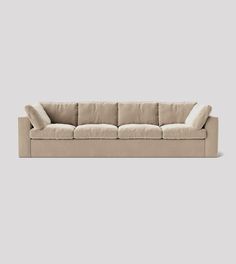 a beige couch with pillows on it