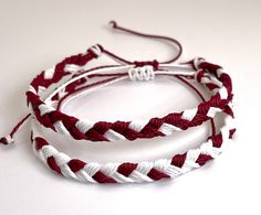 two red and white braided bracelets sitting on top of each other