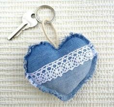 a blue heart shaped keychain with lace on it and a pair of scissors