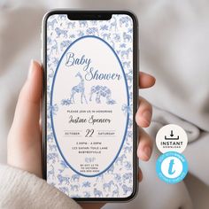 a person holding an iphone with the baby shower app on it