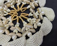 "Cowry or cowrie have historically been used as a currency in several parts of the world, but today extensively for jewellery and for other decorative and ceremonial purposes. Cowry shells are viewed as symbols of womanhood, fertility, birth and wealth. Beautiful beaded cowrie tassels with faux pearl circular applique and braided zari loop to attach. These tassels can be used for various craft work, to decorate bags, gift boxes... or for ethnic jewelry. Size : Total length of the tassel is 3.5\" White Beaded Shell For Festival, Latkan Ideas, Shell Tassels, Beaded Tassels Diy, Tassels Fashion Clothing, Decorated Bags, Saree Tassels, Cowry Shell, Diy Tassel