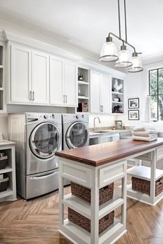 a laundry room with washer, dryer and cabinets in white colors is shown