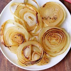 an onion dish on a white plate with onions cut up in half and seasoning