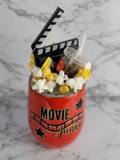 a red cup filled with popcorn and movies