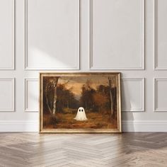 a painting hanging on the wall next to a wooden floor