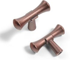 two copper colored knobs on a white background