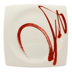 a white plate with red paint on it and the letter o written in red ink