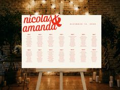 a wedding seating chart is displayed in front of a brick wall