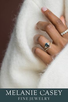 a woman's hand with two rings on her fingers and the words melanie casey fine jewelry