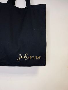 These personalised tote bags are beautifully printed with your own wording in a romantic script font in a choice of metallic colours. These lovely tote bags are the perfect gift for anyone and everyone. The name or word of your choice will be added on the bottom right of your black cotton canvas tote bag in our stunning metallic vinyl foil. A unique gift to add to our collection of items. Depending on your ideas these make a lovely hen party gift, bridesmaids gift ideas or just because. Black canvas bag 100% cotton 42x39x13 Please allow up to 3 working days before despatch for handmade orders. All personalised items are none refunded so please check spellings. Customized Black Rectangular Bag, Black Personalized Canvas Bag For Gift, Customizable Black Canvas Bag For Gift, Customizable Black Canvas Bag For Gifts, Personalized Gold Rectangular Bag, Personalized Rectangular Gold Bag, Personalized Gold Rectangular Bags, Customizable Black Bags For Personalized Gifts, Bridesmaids Gift Ideas