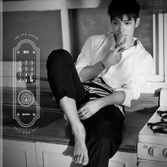 a young man sitting on top of a kitchen counter