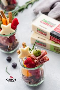 two small glass jars filled with fruit and snacks