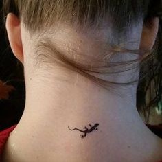 a small lizard tattoo on the neck