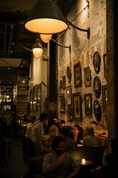 a group of people sitting at tables in a restaurant