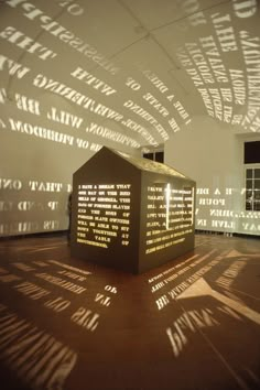 a shadow cast on the wall by a sculpture in a room with windows and shadows