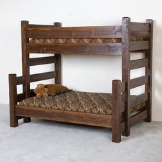 a wooden bunk bed with a stuffed animal on it's bottom and side rails