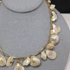 *Description: This is a white enamel over gold tone sea shell charm necklace with real or faux baroque pearls and 8mm faux pearls on the extension chain from the 1950s. This necklace has the same charms as a Napier necklace without the white enamel. I can not find another one like it. This is very similar to this Napier necklace with the same shape of clam and oyster shells but this necklace is unsigned. The pearls may be real baroque or may be faux. No matter which is accurate, it is a wonderfu Vintage Gold Shell Jewelry, Vintage Pearl Necklace With Metal Pearl Charm, Vintage Shell Gold Jewelry, Vintage Pearl Necklace With Lobster Clasp, Vintage Pearl Jewelry With Lobster Clasp, Vintage Shell Shaped Jewelry, Vintage Shell Necklace Gift, Vintage White Shell Necklace, Vintage Shell Necklace For Gift