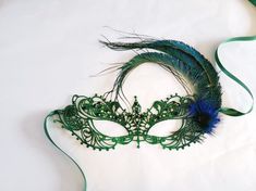 Emerald Green feather mask women, green masquerade Mask woman, Emerald Green venetian mask, Green theme masquerade masks women Lightweight lace base painted & embellished in colors listed or custom painted to match your outfit. If you chose mixed Rhinestone color option, pls leave a note during check out with the color choices. Feel free to request images of rhinestones if you are unsure what shade is needed to match your attire. S H I P P I N G - Processed same day or within 24 hours. 1-2 d