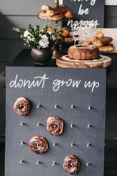 doughnuts on display in front of a sign that says donut grow up