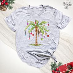 Christmas Lights Palm Tree Shirt, Tropical Christmas Holiday T-shirt, Hawaii Island Christmas Shirt, Beach Aloha Christmas Party Outfit Hello, Welcome to Blue Unique Boutique, your destination for unique and handcrafted shirts! I'm Eve! I have been thinking about creating my business for a long time and now I have taken the first step towards it and it gives me excitement. As a small business, I take pride in creating unique designs from the comfort of our homes. Each shirt is carefully crafted Outfits Florida, Palm Tree Shirt, Christmas Palm Tree, T Shirt 2023, Christmas Party Outfit, Tropical Christmas, Tee Tree, Shirt 2023, Christmas Outfits