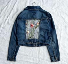 Hand-sewn upcycled jean jacket with floral mesh back. Old Navy size Women's Small. Machine washable, trim loose threads as needed. All profits go to sponsoring a child and her community through Save The Children. For more sizes and styles, contact me or visit my shop at https://www.etsy.com/shop/GiftsForGirlsStudio?ref=l2-about-shopname Spring Recycled Denim Fitted Jacket, Spring Fitted Recycled Denim Jacket, Spring Recycled Denim Patchwork Outerwear, Spring Patchwork Recycled Denim Outerwear, Spring Patchwork Outerwear In Recycled Denim, Fitted Denim Jacket With Patches For Spring, Spring Upcycled Recycled Denim Jacket, Upcycled Long Sleeve Denim Jacket For Spring, Spring Upcycled Long Sleeve Denim Jacket