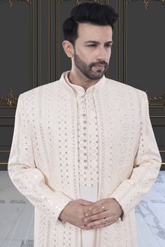 This Mens Sherwani (M42-S133) is an open jacket style with exquisite sequin and thread embroidery. The intricate detailing adds a touch of elegance to this traditional attire. Perfect for weddings and special occasions, this sherwani is a must-have for anyone looking to make a statement. Elegant Sherwani With Chikankari Embroidery For Festivals, Bollywood Style Formal Outerwear With Resham Embroidery, Formal Bollywood Outerwear With Resham Embroidery, Elegant Bandhgala With Chikankari Embroidery For Eid, Elegant Eid Bandhgala With Chikankari Embroidery, Traditional Drape Bandhgala With Naqshi For Reception, Transitional Bandhgala With Intricate Embroidery, Wedding Bandhgala With Dabka Work For Eid, Elegant Nehru Jacket With Dabka Work For Eid