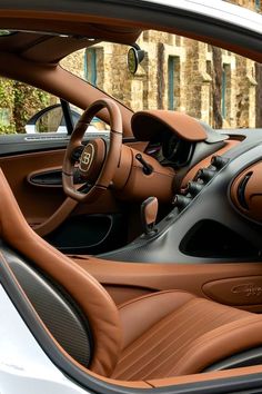 the interior of a sports car with brown leather