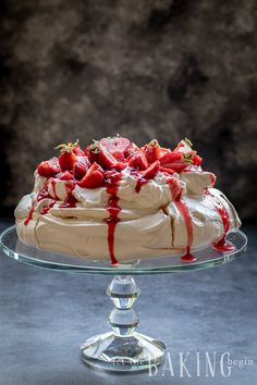 a cake with strawberries on top and icing drizzled over it