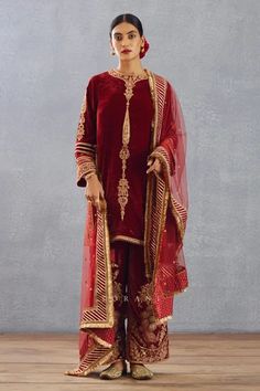 Bright red kurta with gold thread and sequin embroidered motifs. Comes with phiran and silk organza dupatta.
Component: 3
Pattern: Embroidery
Type Of Work: Thread, Gota Patti and Sequin
Neckline: Round
Sleeve Type: Full
Fabric: Silk Velvet, Cotton Voile and Silk Organza
Color: Red
Other Details: 
Dupatta with gota patti border and fringe detail
Side slits
Low back with tie and tassels
Phiran with embroidered hem
Occasion: Wedding - Aza Fashions Red Kurta, Indian Textiles, Organza Dupatta, Silk Organza, Fabric Silk, Red Silk, Cotton Voile, Silk Velvet, Silk Crepe