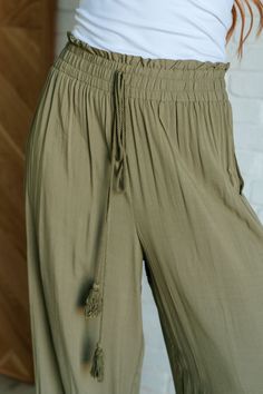 Embark on a stylish journey with our Exciting Escapade Wide Leg Pants, crafted to blend comfort with playful style. Made from woven fabric, these pants offer a lightweight and breathable feel, perfect for all-day wear. The cased elastic waistline ensures a comfortable fit while the ruffle details and geometric embroidery add charm. Woven Cased Elastic Waistline Ruffled Waistline Decorative Tasseled Drawstring Straight Leg Embroidered Detail Functional Side Pockets 100% Viscose True to Size S: Wa Comfortable Spring Harem Pants With Elastic Waistband, Relaxed Ankle-length Harem Pants With Elastic Waistband, Summer Comfortable Harem Pants With Elastic Waistband, Comfortable Summer Harem Pants With Elastic Waistband, Stretch Harem Pants With Elastic Waistband For Vacation, Summer Loungewear Pants With Elastic Waistband, Comfortable Lightweight Bottoms With Relaxed Fit, Comfortable Lightweight Relaxed Fit Bottoms, Relaxed Fit Parachute Pants For Vacation