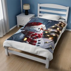 a bed with a snowman and christmas lights on it