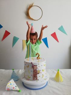 a young boy standing in front of a birthday cake