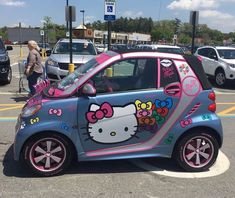 a hello kitty car parked in a parking lot