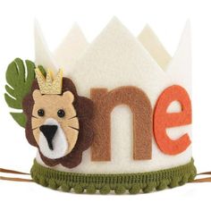 a small crown with a lion on it's head and the word one is made out of felt